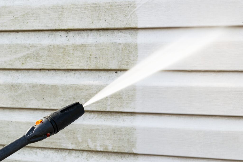 Cleaning service washing building facade with pressure water. Cleaning dirty wall with high pressure water jet. Power washing the wall. Cleaning the facade of the house. Before and after washing. Pressure Washing Pollen