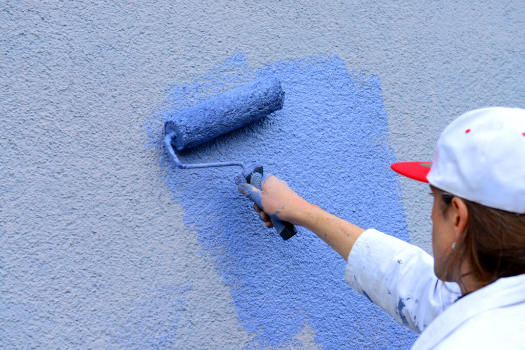 Everything You Need To Know About Pressure Washing Pollen Before Painting workman painting the wall with paint roller, Pressure Washing Pollen